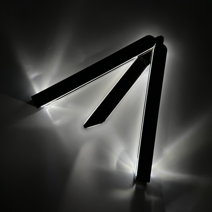 Partially open EOS balisong with fiber optic technology for visibility in darkness and an anodized black finish, casting a bright glow along the edges against a dark background, highlighting its sleek and modern design.