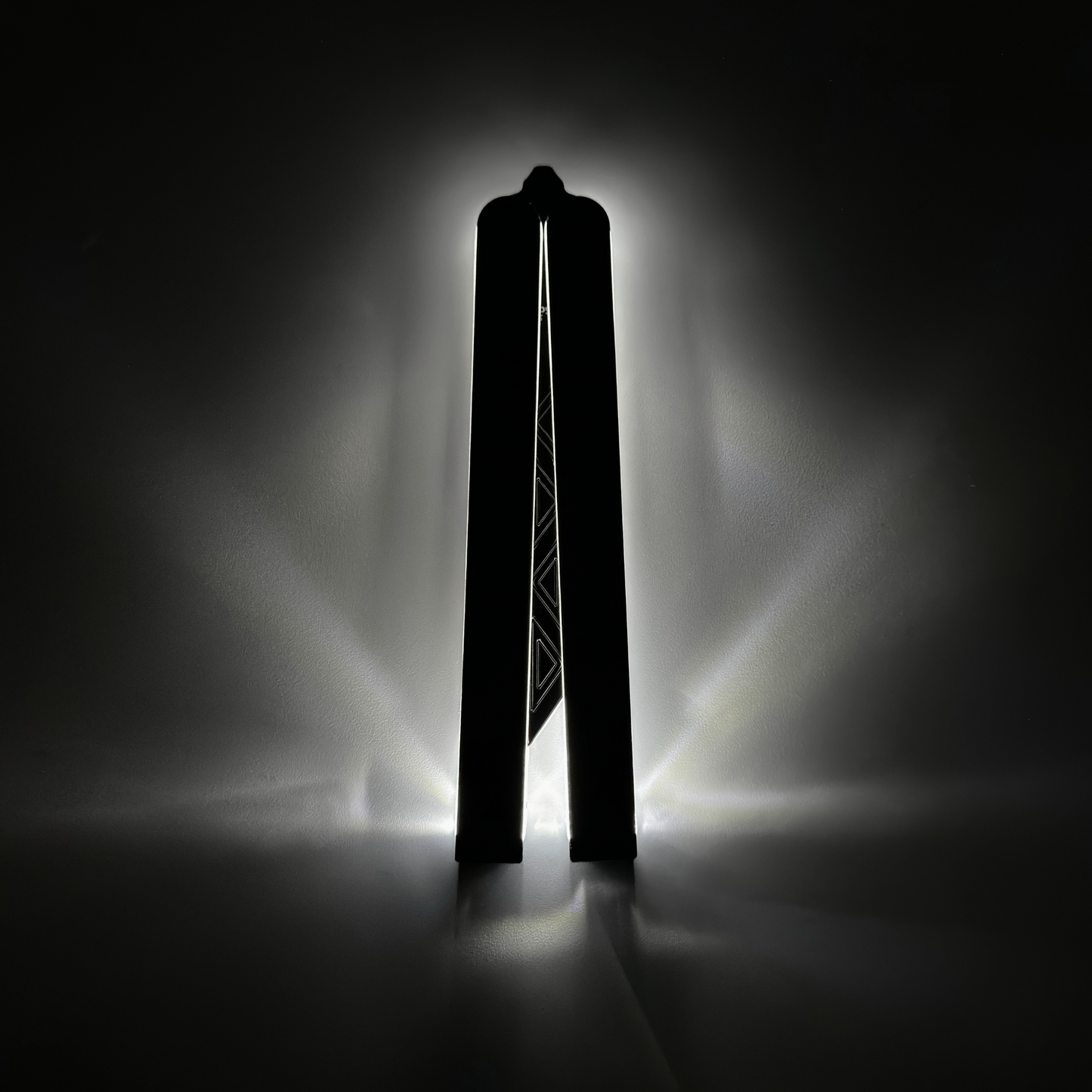 Closed EOS light-up butterfly trainer with glowing fiber optic cables embedded in a sleek Aluminum 7075 body, showcasing a modern design and a luminous outline for enhanced visibility in low light.